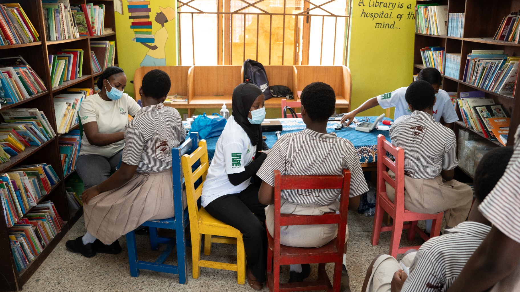 Students receiving screenings inside the school library